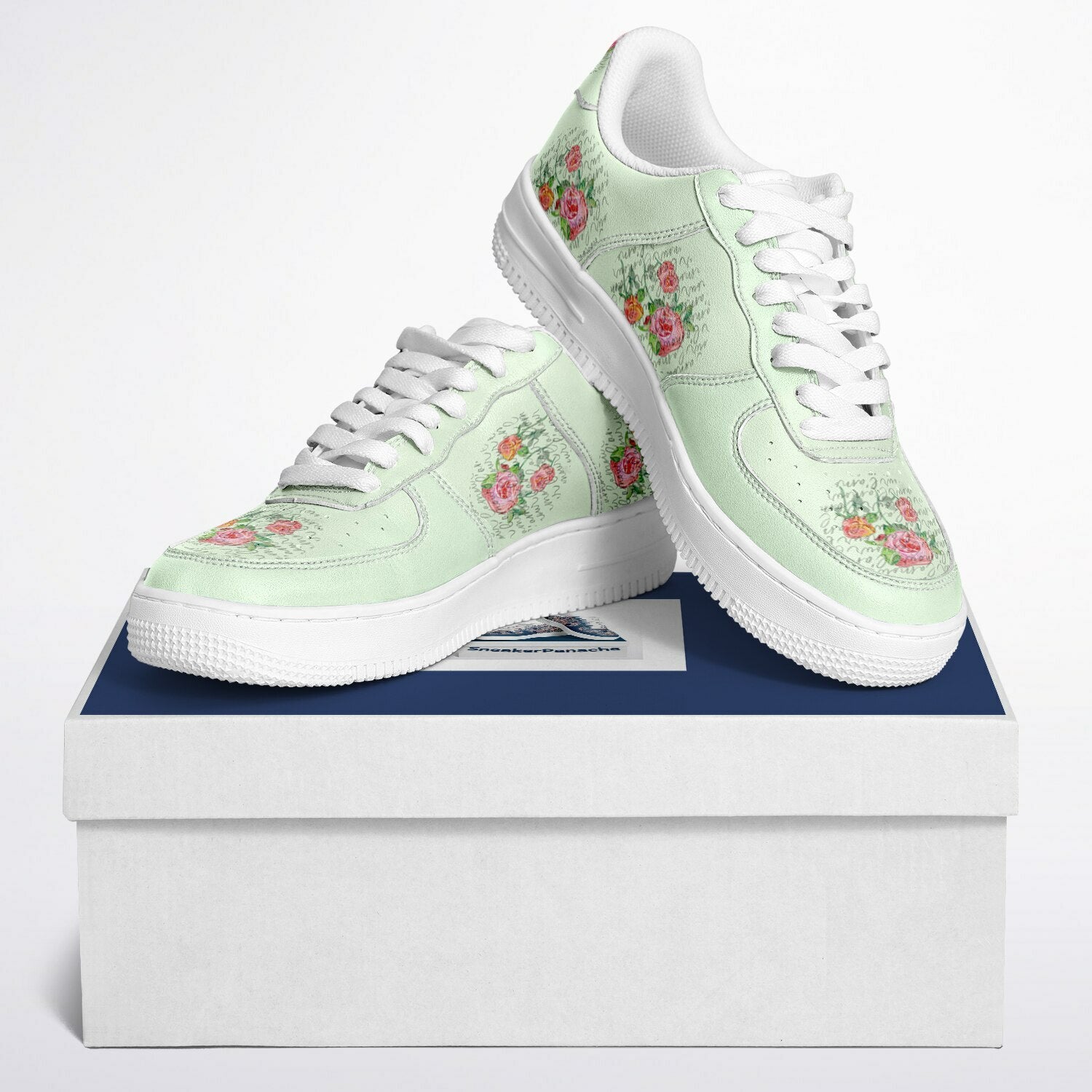 Low top sneakers in mint with script and pink roses.